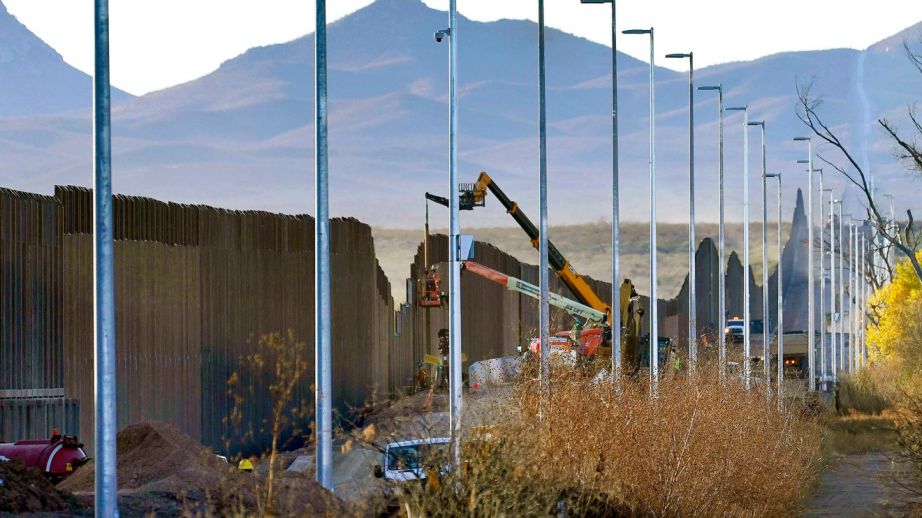 Crews construct a section of border wall in San Bernardino National Wildlife Refuge, Tuesday, Dec. 8, 2020, in Douglas, Ariz.