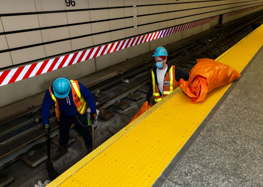 MTA employees clean subway tracks at 96th street station, last stop of Q line during COVID-19 pandemic