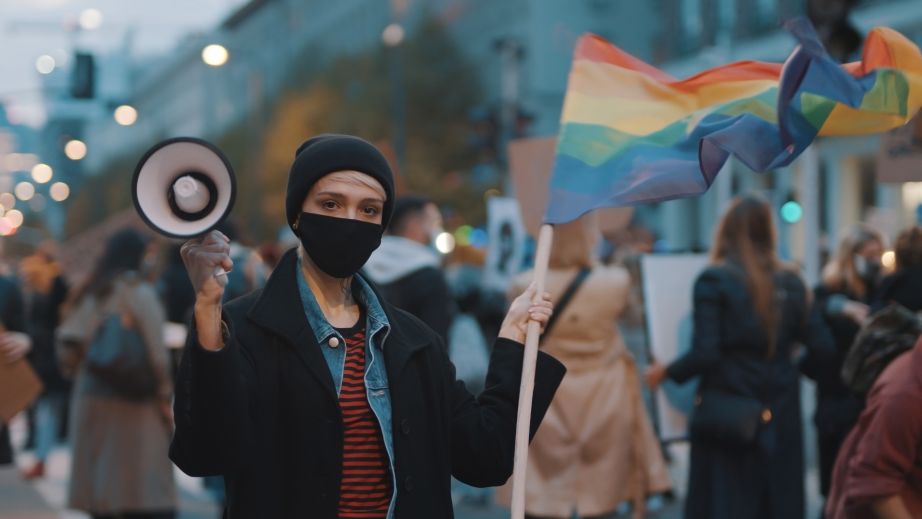 Woman in a protest with a Pride Flag