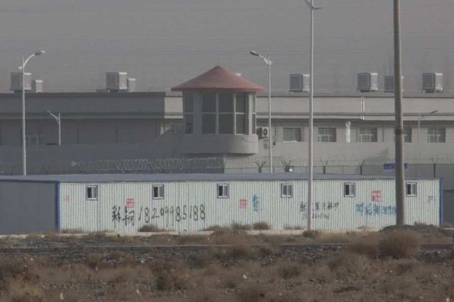 a guard tower and barbed wire fences are seen around a facility in the Kunshan Industrial Park in Artux in western China's Xinjiang region.