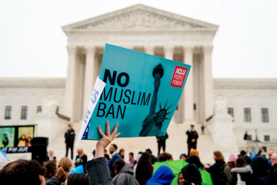 A person holds up a sign that reads "No Muslim Ban" during an anti-Muslim ban rally