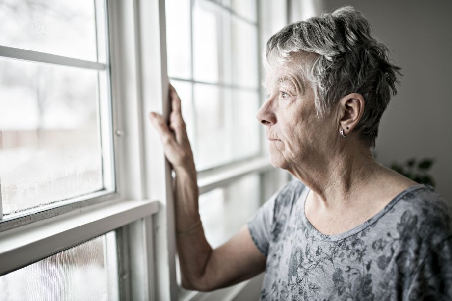 Old woman looking out the window