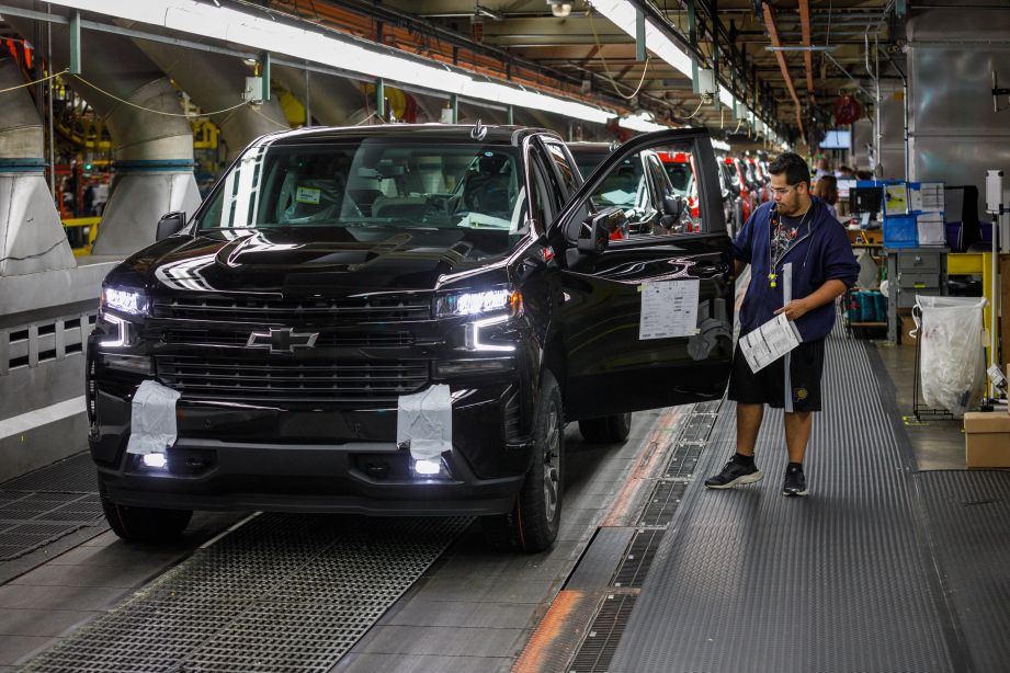 Trucks come off the assembly line at GM's Chevrolet Silverado and GMC Sierra pickup truck plant