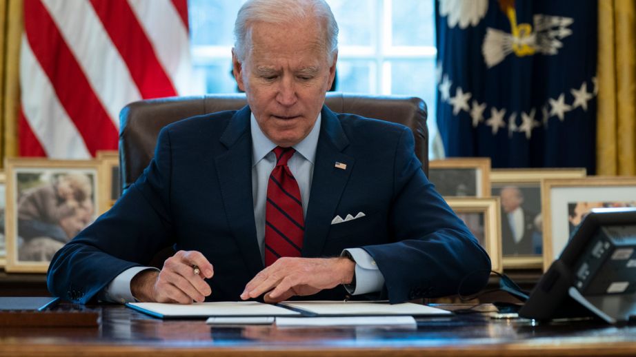 President Joe Biden signs a series of executive orders on health care, in the Oval Office of the White House, Thursday, Jan. 28, 2021, in Washington.