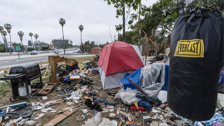 In this May 11, 2021, file photo, a trashed punching bag is left at a homeless encampment on the side of the CA-101 highway in Echo Park neighborhood in Los Angeles. (AP Photo/Damian Dovarganes)