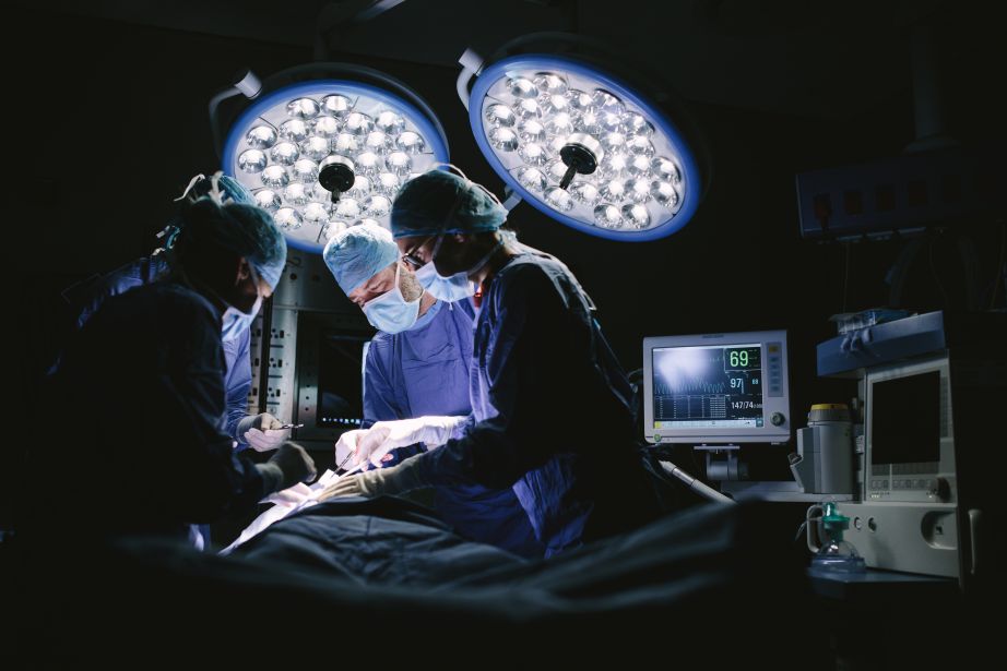 Doctors operating in surgery room