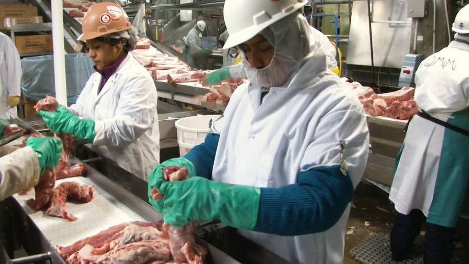 Workers at a meat processing plant