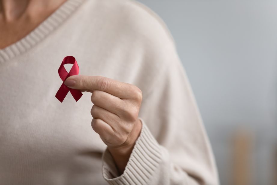 woman with red ribbon representing world aids day