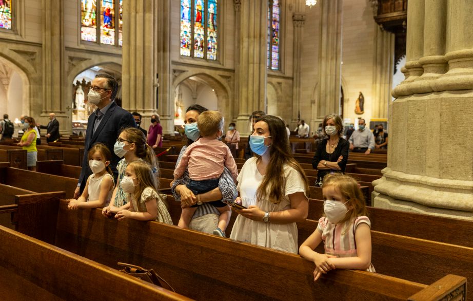 A family prays during St. Patrick's Cathedral Sunday first public Mass since March when pandemic stopped large gatherings