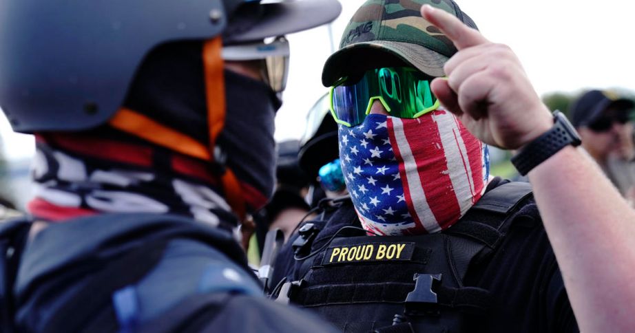 member of the Proud Boys, right, stands in front of a counter protester as members of the Proud Boys and other right-wing demonstrators rally, in Portland.  (AP Photo/John Locher, File)